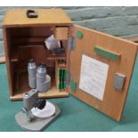A cased Olympus laboratory microscope,