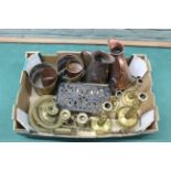 A box of brass and copper wares including candlesticks,