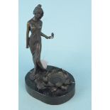 A bronze figurine of a woman with lotus flower, marked Milo on black marble base, 23.