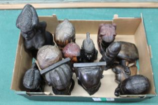 A large box of mixed tribal carved wooden heads and figures including a pair of bookends