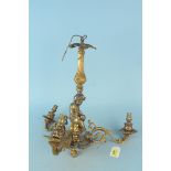 An antique solid brass three branch candelabra with cherubs