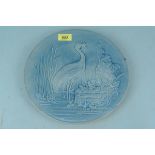 An early 20th Century Burmantofts Faience glazed plate decorated with a heron with frog in beak,