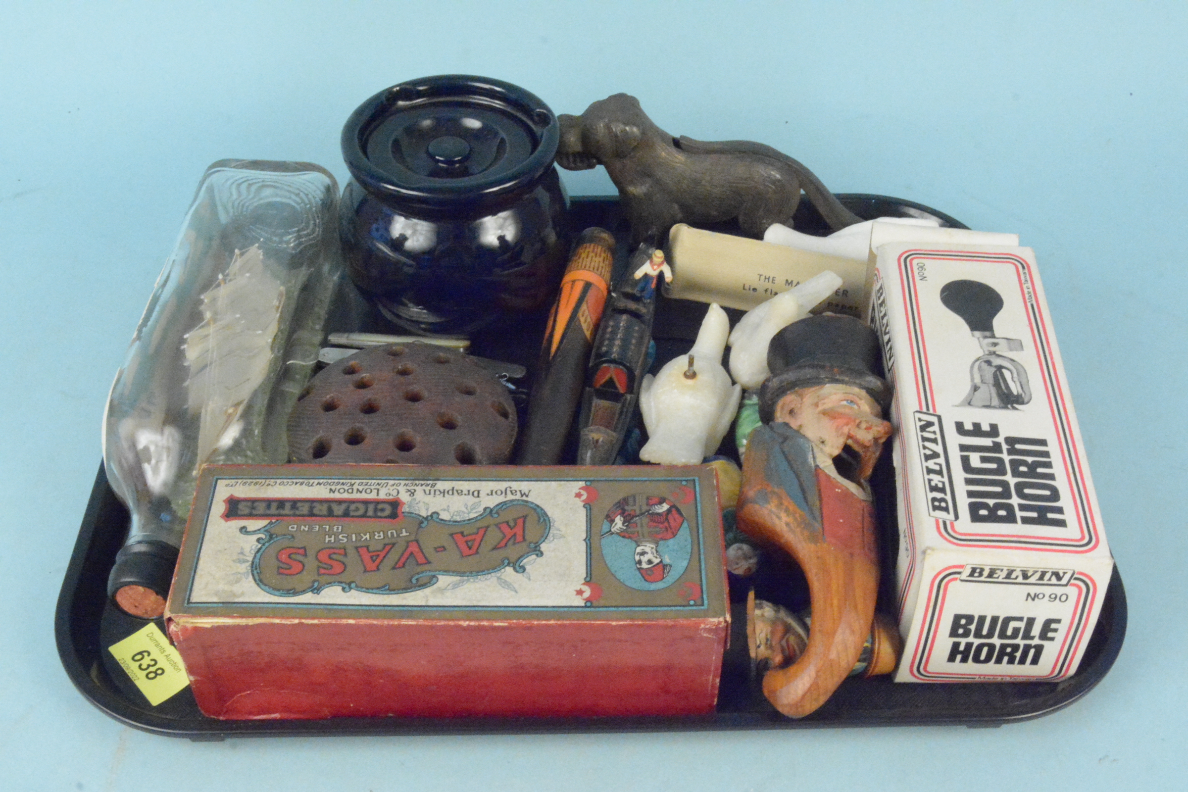 Mixed items of interest including a ship in a bottle, metal dog nut cracker,