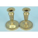 A pair of early 19th Century French brass candlesticks with fluted and chased decoration, 12.