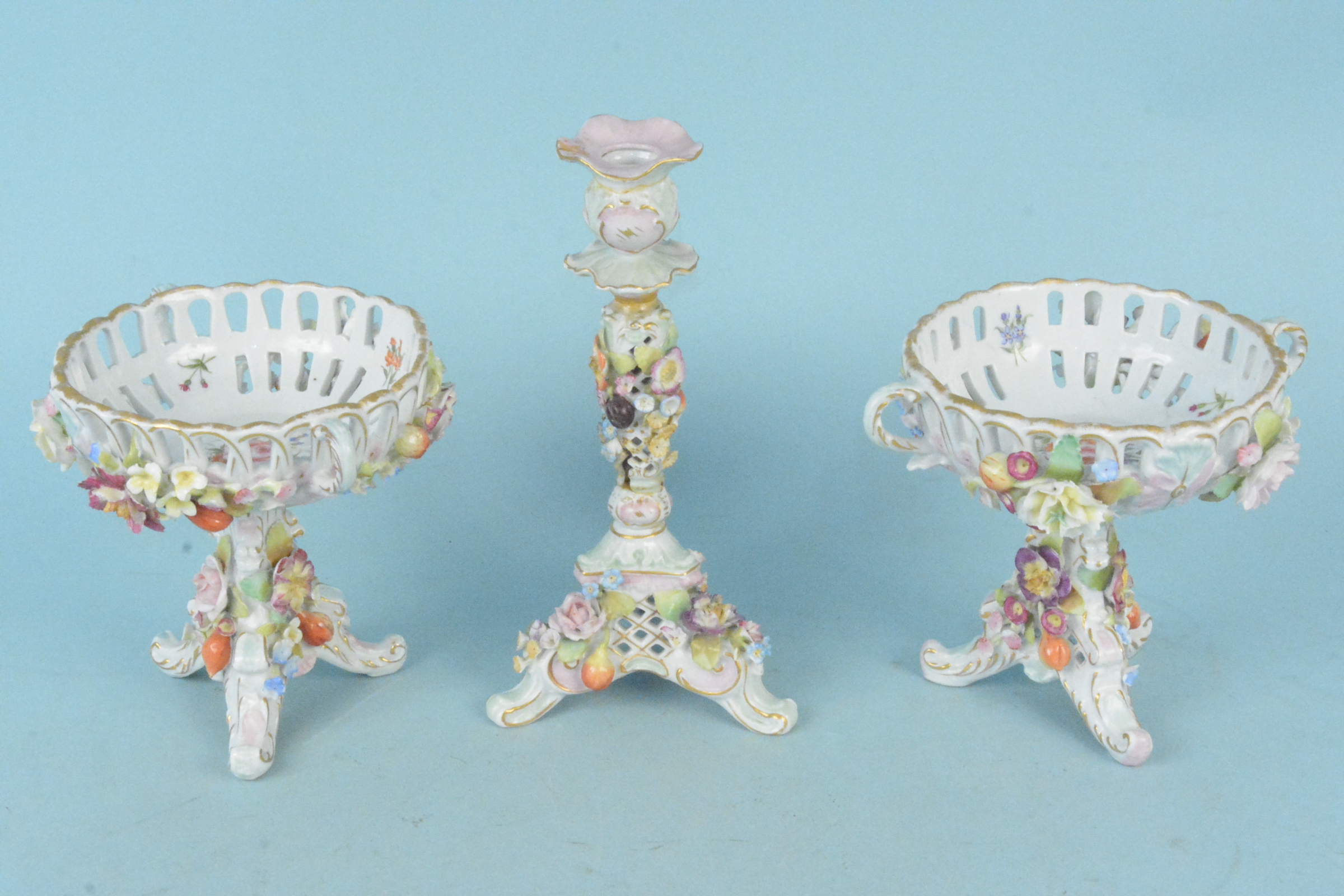 A pair of antique Dresdon hand painted bon bon dishes elaborately decorated with flowers,