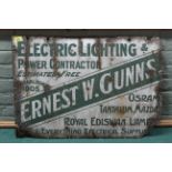A vintage enamel on metal advertising sign 'Ernest W Gunns Electric Lighting'
