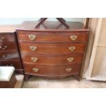 An early 19th Century mahogany four drawer bow front chest (one broken foot,