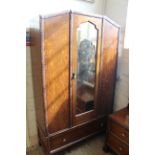 A 1930's oak wardrobe with shallow carved mouldings