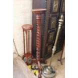 A mahogany torchere with a twisted column on bold carved tripod legs