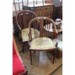 A pair of Edwardian mahogany inlaid open armchairs on turned legs