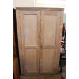 An early 20th Century pine two door cupboard with ply panels