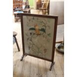 A 1920's needlework and oak firescreen