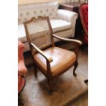 A 1930's beech framed open armchair with cane back