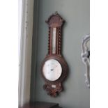 An Edwardian carved oak barometer