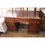 A Victorian style mahogany seven drawer desk