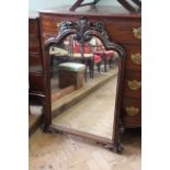 A carved wood overmantle mirror