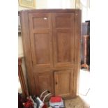 A 19th Century oak four door corner cupboard with shaped shelves