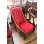 A Victorian walnut framed lady's chair with red upholstery