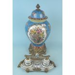 A large Oriental style lidded vase on metal bases,