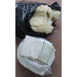 A bag of various linen tablecloths plus three sheepskin rugs in a bag