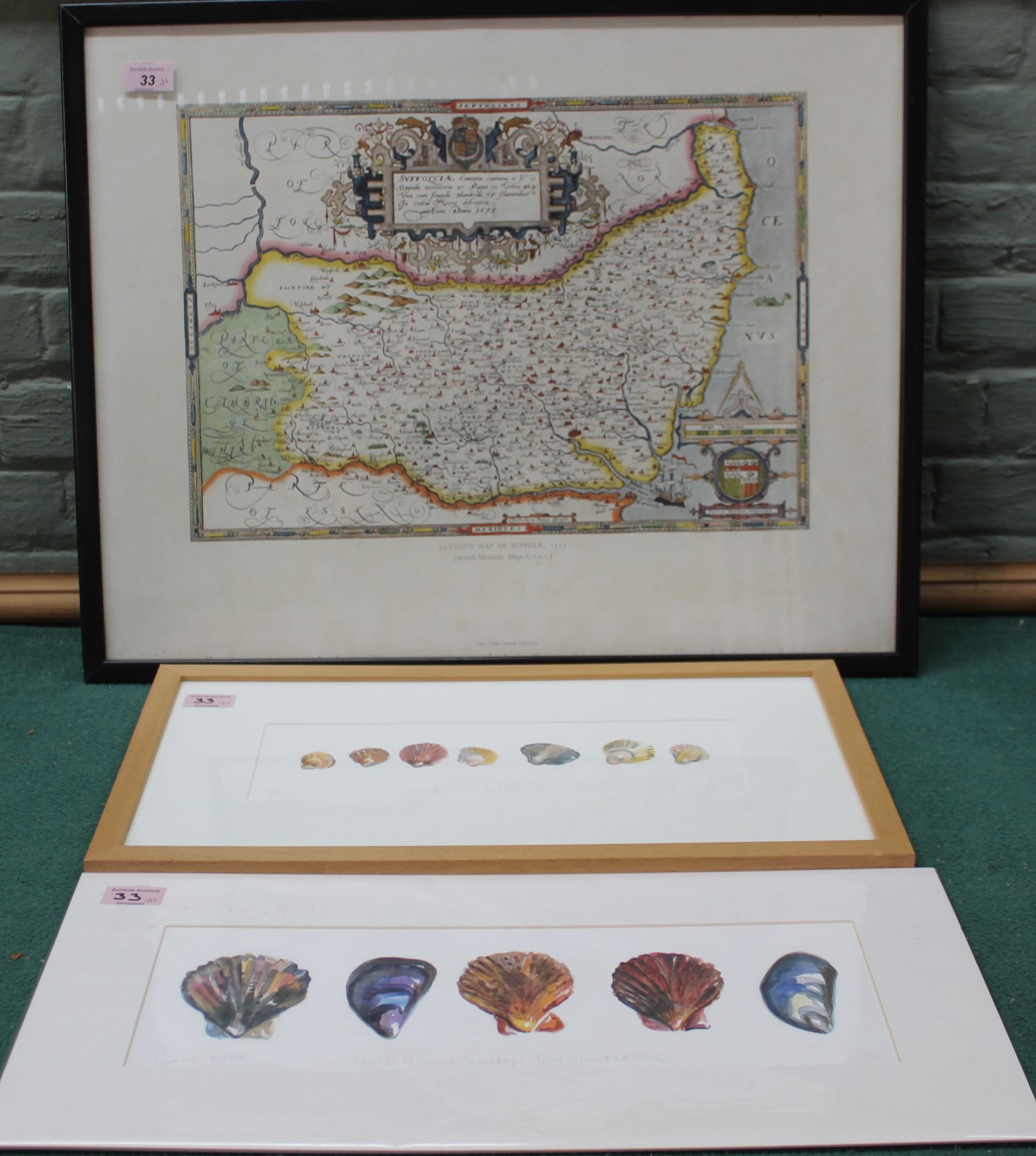 A framed printed Saxton's map of Suffolk plus framed and loose Susie Yates prints of shells,