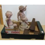 A pair of antique composite cherubs on bases (weather worn and both damaged) plus a cast iron peg