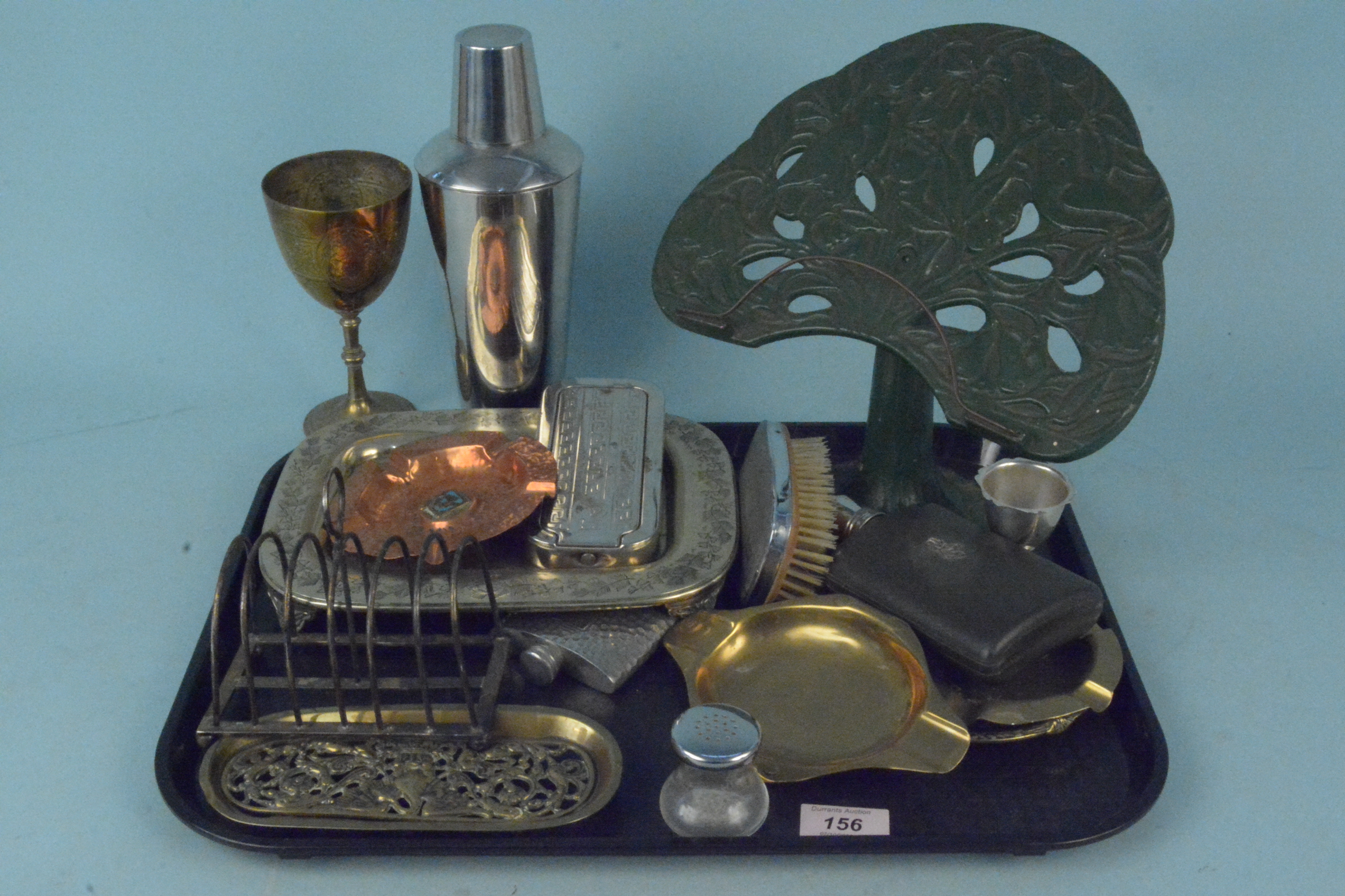 Assorted metal wares to include vintage ash trays, cast iron book stand, plated cocktail shakers,