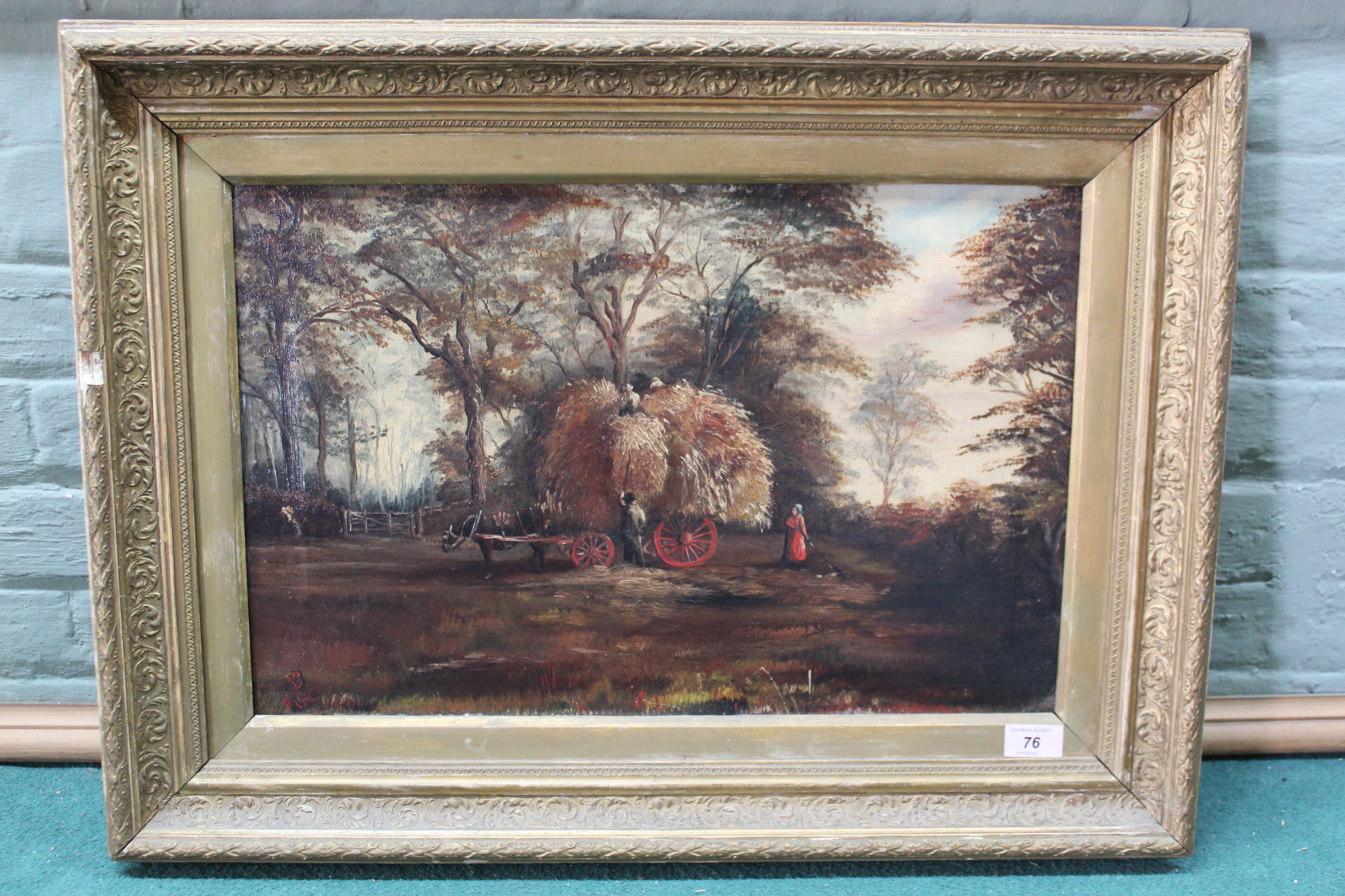 A late 19th Century framed oil on canvas of a loaded hay wain with figures in a landscape,