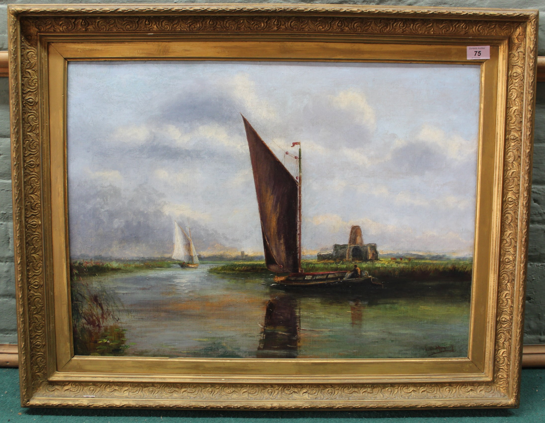 A late 19th Century framed oil on canvas of a wherry passing St Benets Abbey on the River Bure