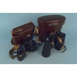 A cased set of Carl Zeiss Jena Jenoptem 10x50W binoculars (one inner lens with chips) plus a pair