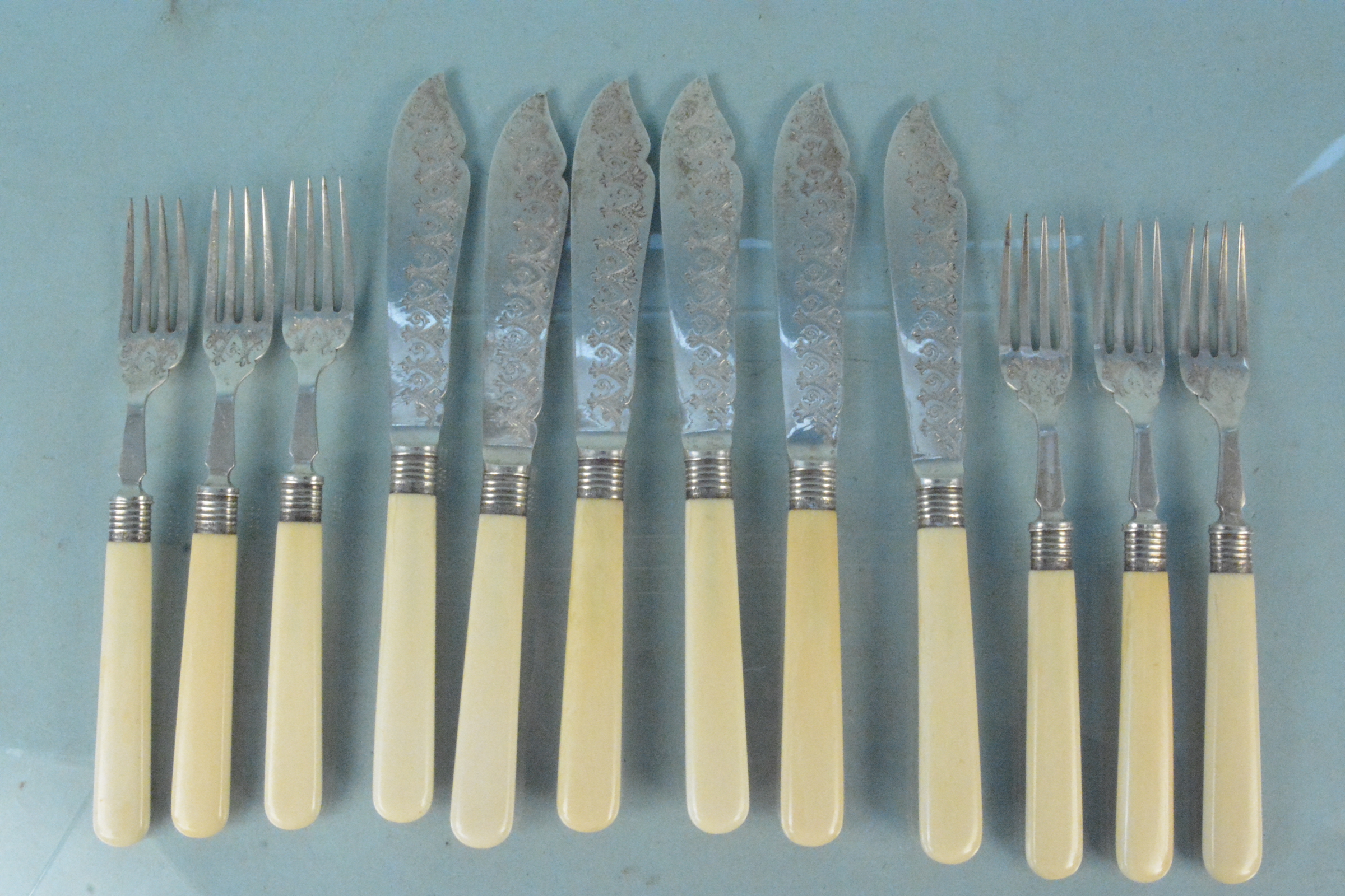 A set of six silver bladed fish knives and forks, hallmarked Sheffield 1905,