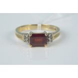 A 10ct gold red stone and diamond set ring,