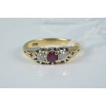 An 18ct gold ruby and diamond three stone ring, size O, weight approx 4.