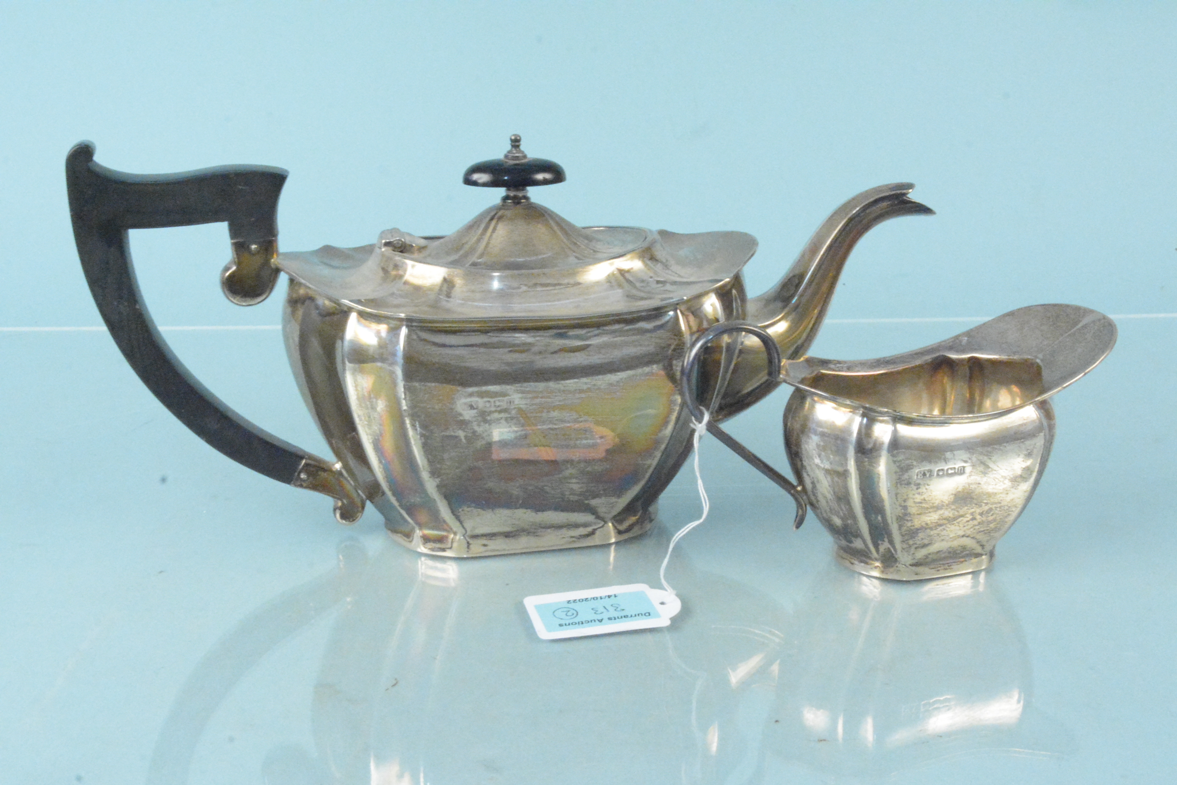 A silver teapot and cream jug, hallmarked Sheffield 1930, maker Viners Ltd,