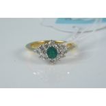 An 18ct gold emerald and diamond cluster ring,