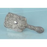 An ornate florally embossed hand mirror (as found)
