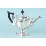An Edwardian silver teapot on flared pedestal base with wooden handle, hallmarked London 1906,