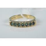 A 9ct gold ring with emeralds,