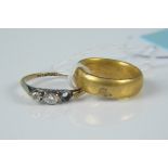 An 18ct gold cased wedding band plus a 9ct platinum set three stone diamond ring (one missing)
