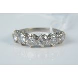 An 18ct white gold six stone diamond ring (one diamond is chipped), size P, weight approx 4.