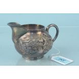A Chinese silver cream jug with dragon design to main body, character mark to base,