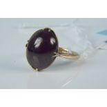 An antique 9ct gold ring set with red cabochon stone (possibly foil backed), size N 1/2,