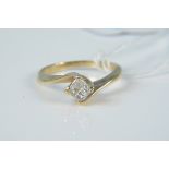 A 14ct gold diamond set ring, the four small square shaped diamonds in raised four claw setting,