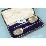 A cased pair of silver gilt anointing spoons, hallmarked Chester 1905,