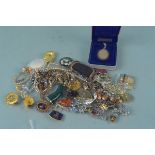 A quantity of costume and silver jewellery including a silver charm bracelet