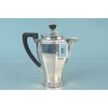 A silver water jug of octagonal design with wooden handle and finial, hallmarked Birmingham 1931,