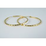 A pair of high carat gold large hoop earrings, stamped 22,