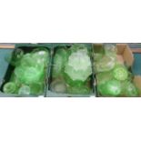 Three boxes of vintage green glassware including lidded jars, vases,