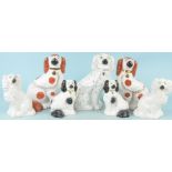 Three pairs and one single Staffordshire pottery spaniels