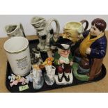 A group of Staffordshire style jugs and figures, a cat ornament, Sylvac Toby jug,